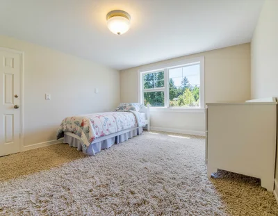 Empty Bedroom With Single Bed And White Dresser