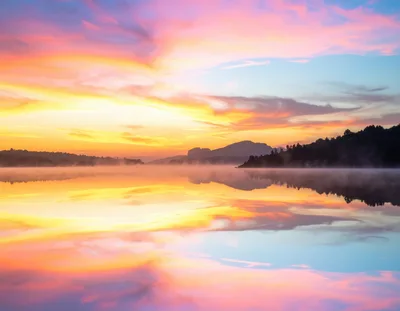 Stunning Sunrise Over A Calm Misty Lake