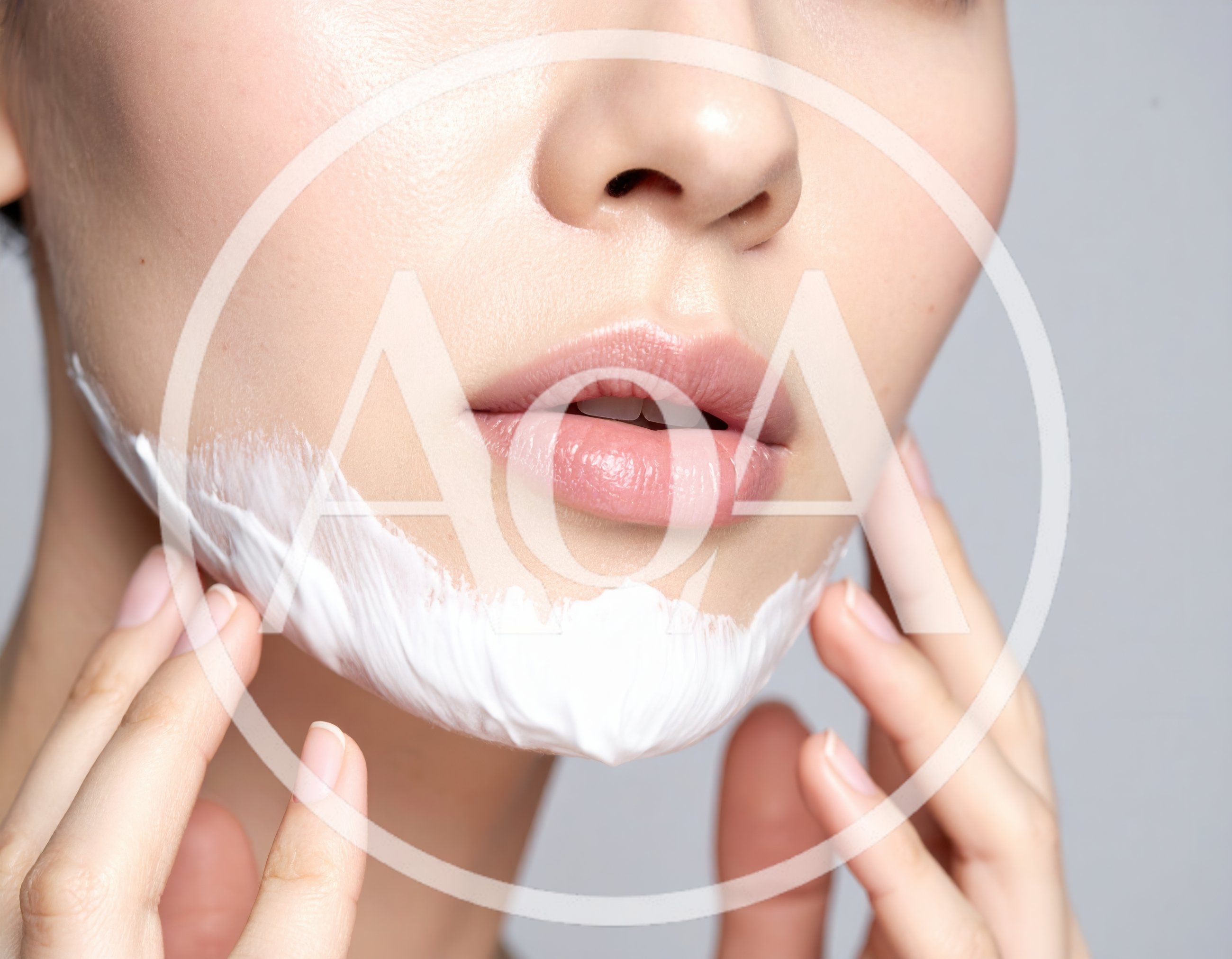 Woman Applying White Skincare Cream To Her Chin