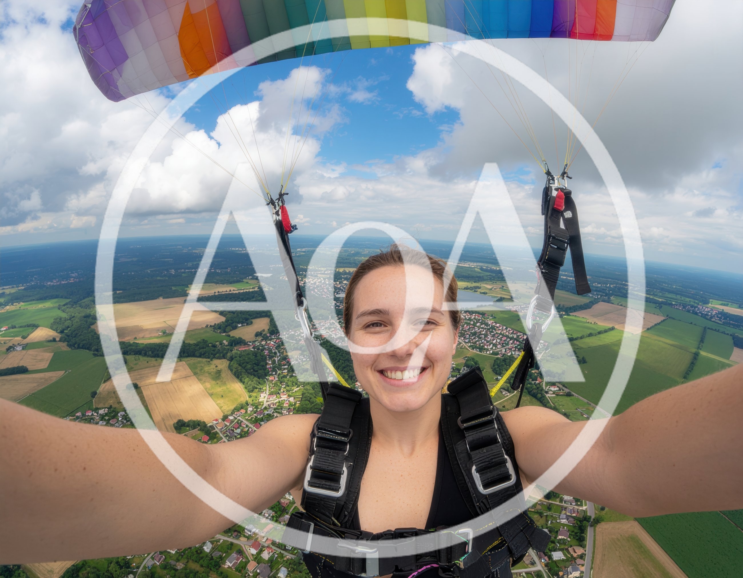 Young Woman Paragliding Over Scenic Countryside Landscape