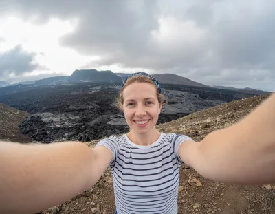 Woman Taking Selfie At Volcanic Landscape