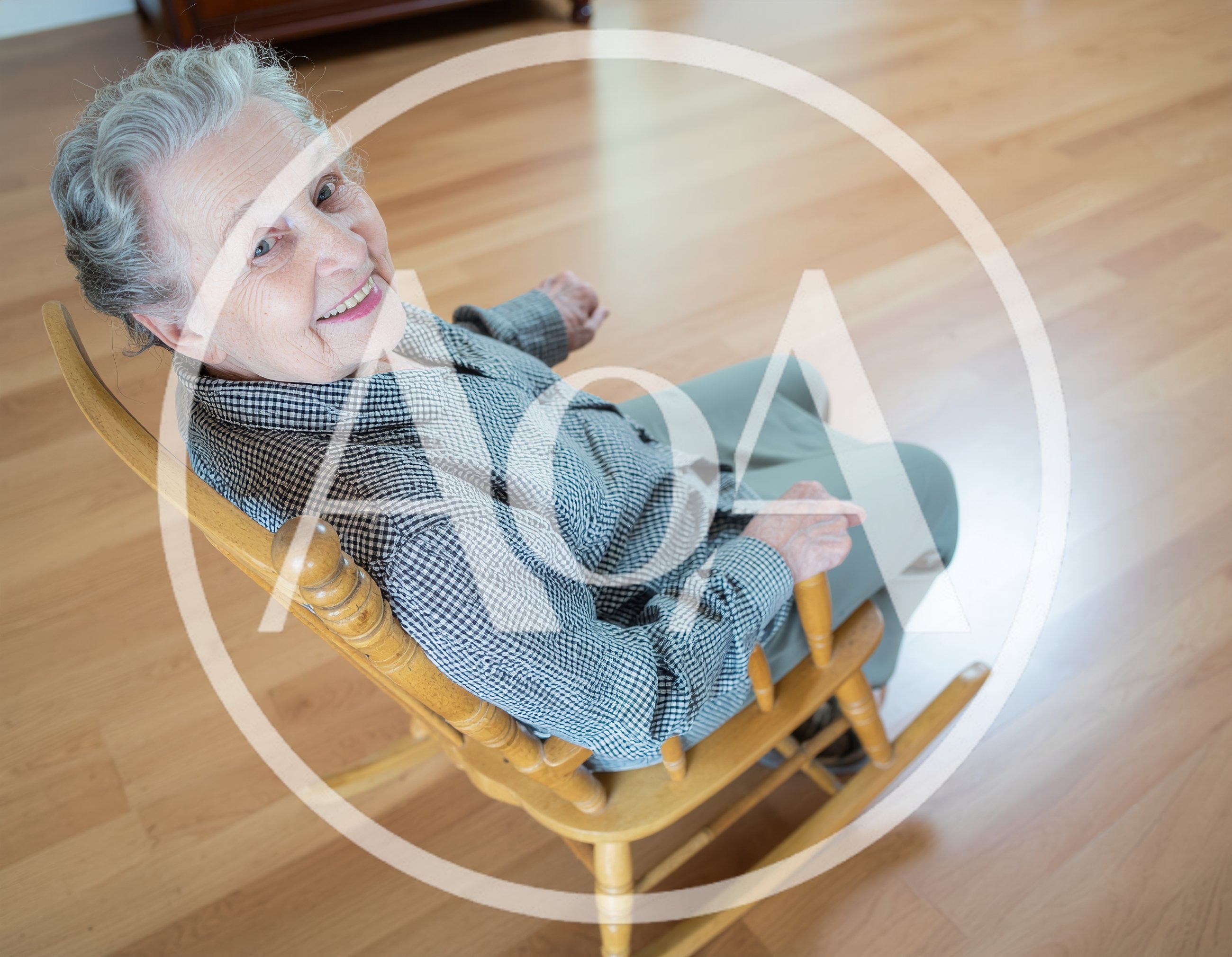 Senior Woman Smiling In A Wooden Rocking Chair