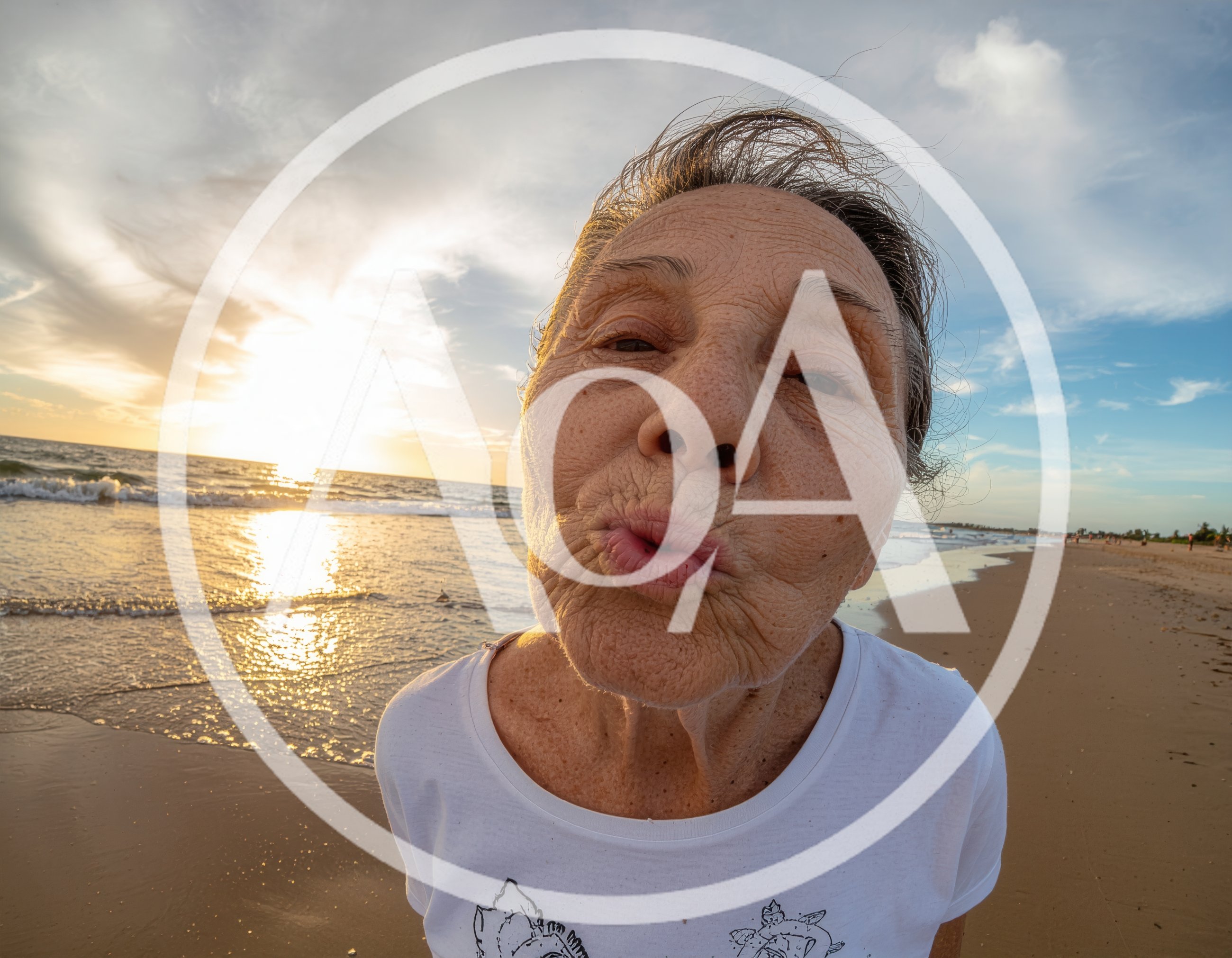 Elderly Woman Making A Kissing Face On The Beach