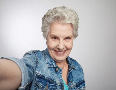 Senior Woman Taking A Selfie In Denim Jacket