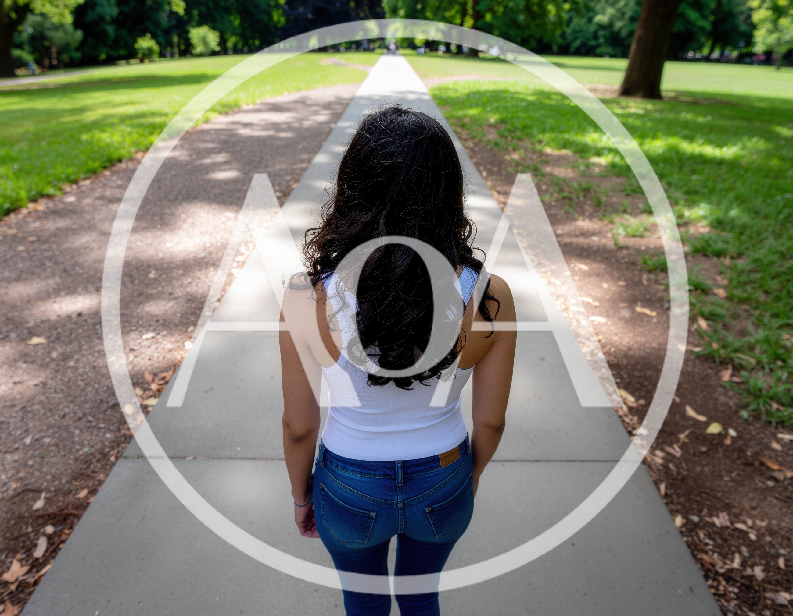 Woman Walking Away On A Park Path