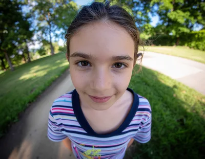 Young Girl Looking Directly Into Fisheye Camera Lens