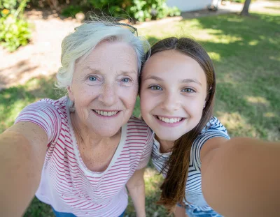 Grandmother and Granddaughter Taking a Selfie Outdoors