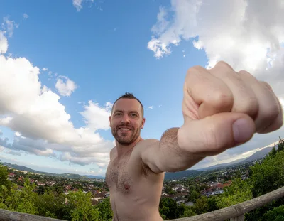 Shirtless Man Posing With Fist Forward Outdoors