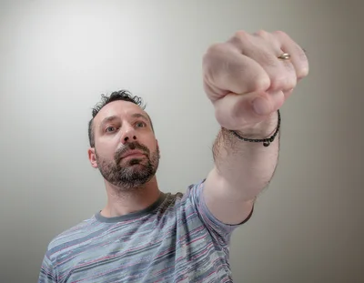 Man Holding Fist Forward In Determination