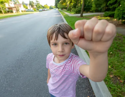 Young Boy Holding Fist Toward Camera