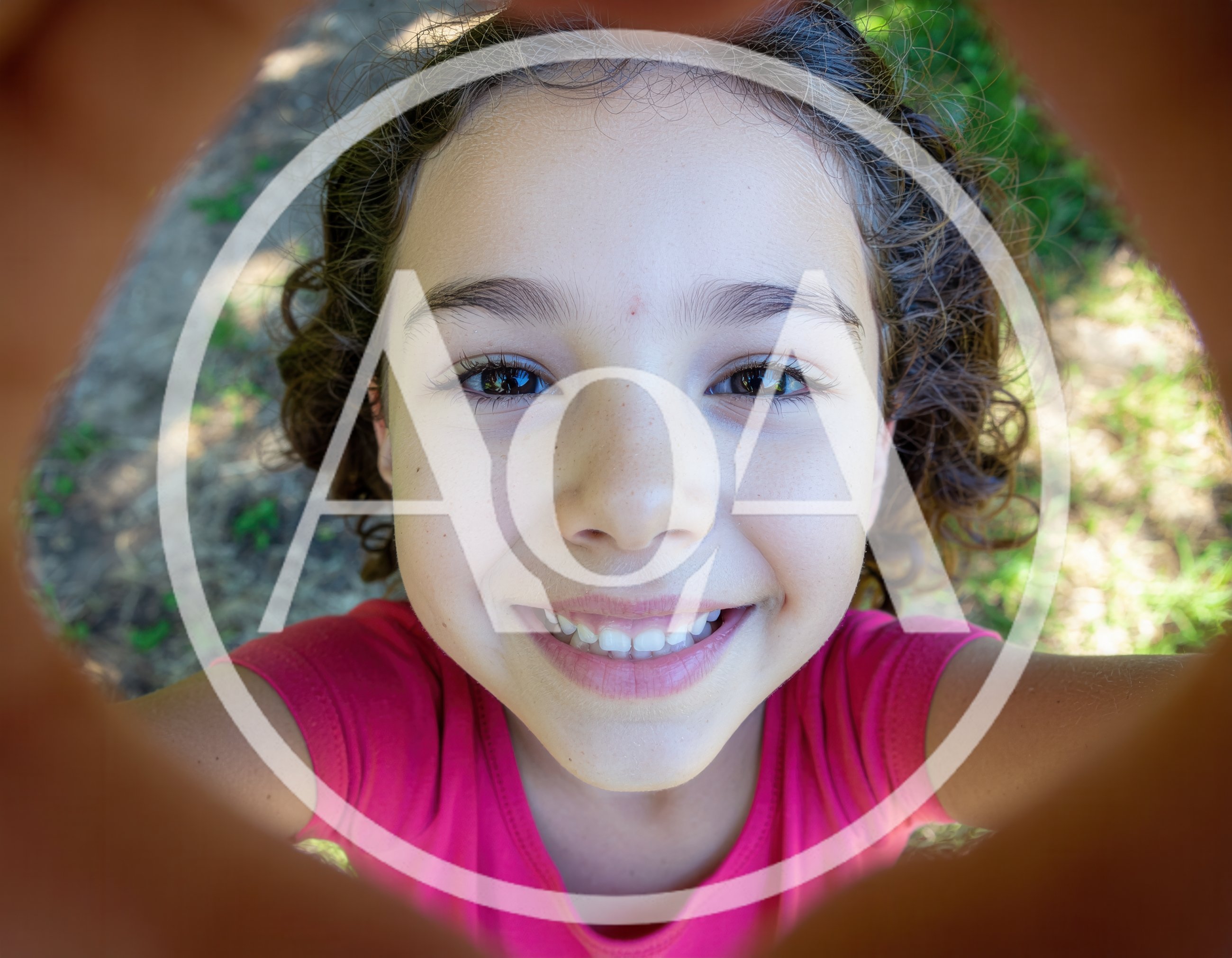 Young Girl Looking Through A Circular Playground Tunnel
