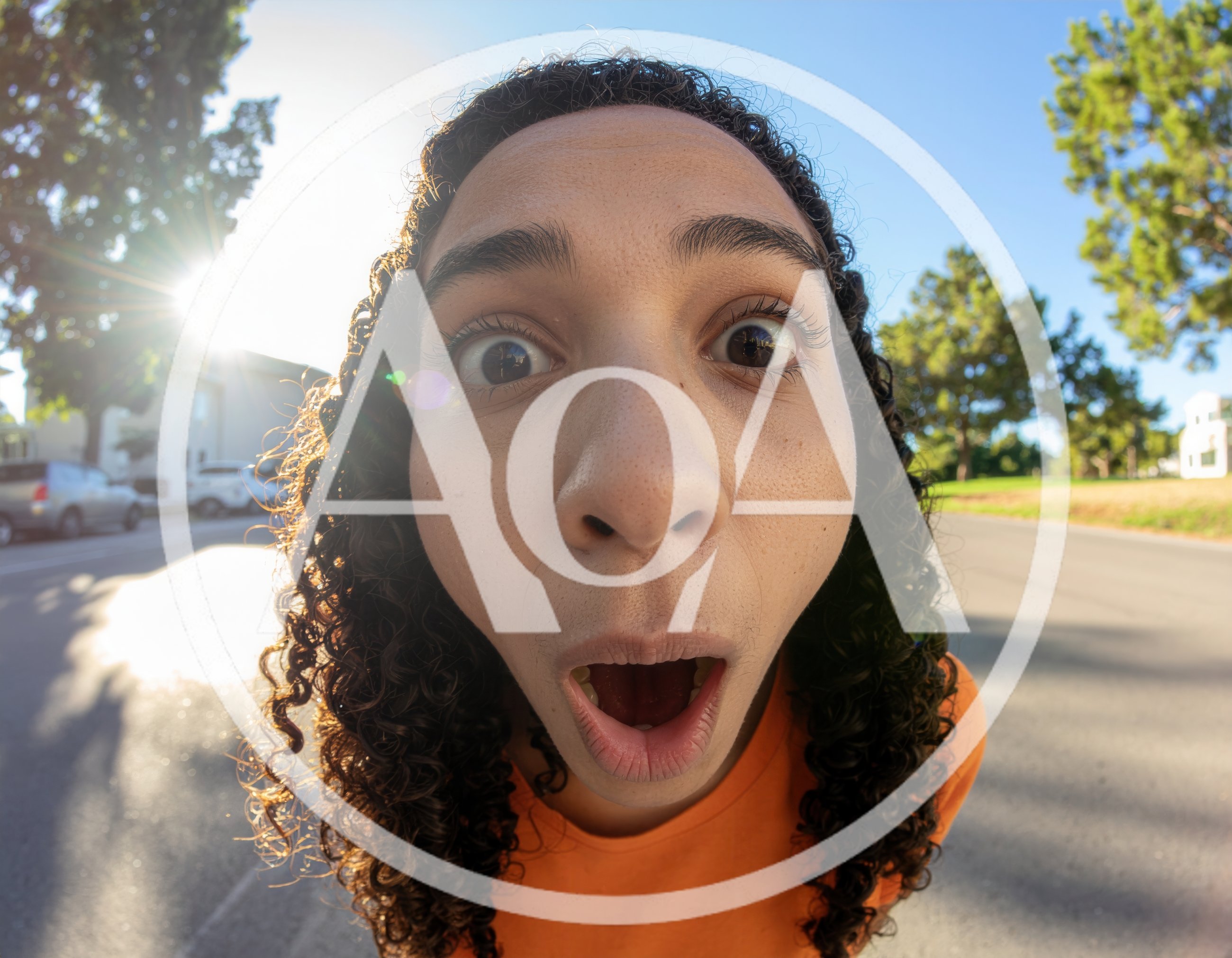 Young Person With Curly Hair Making Surprised Expression
