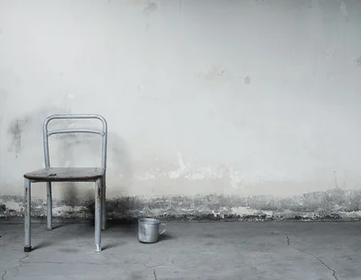 Old Metal Chair And Cup In A Dilapidated Room
