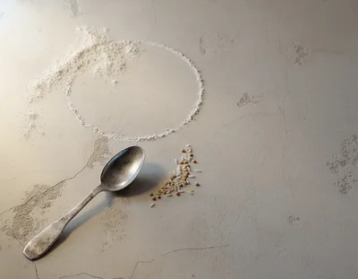 Spoon With Grains And Flour Circle On Concrete