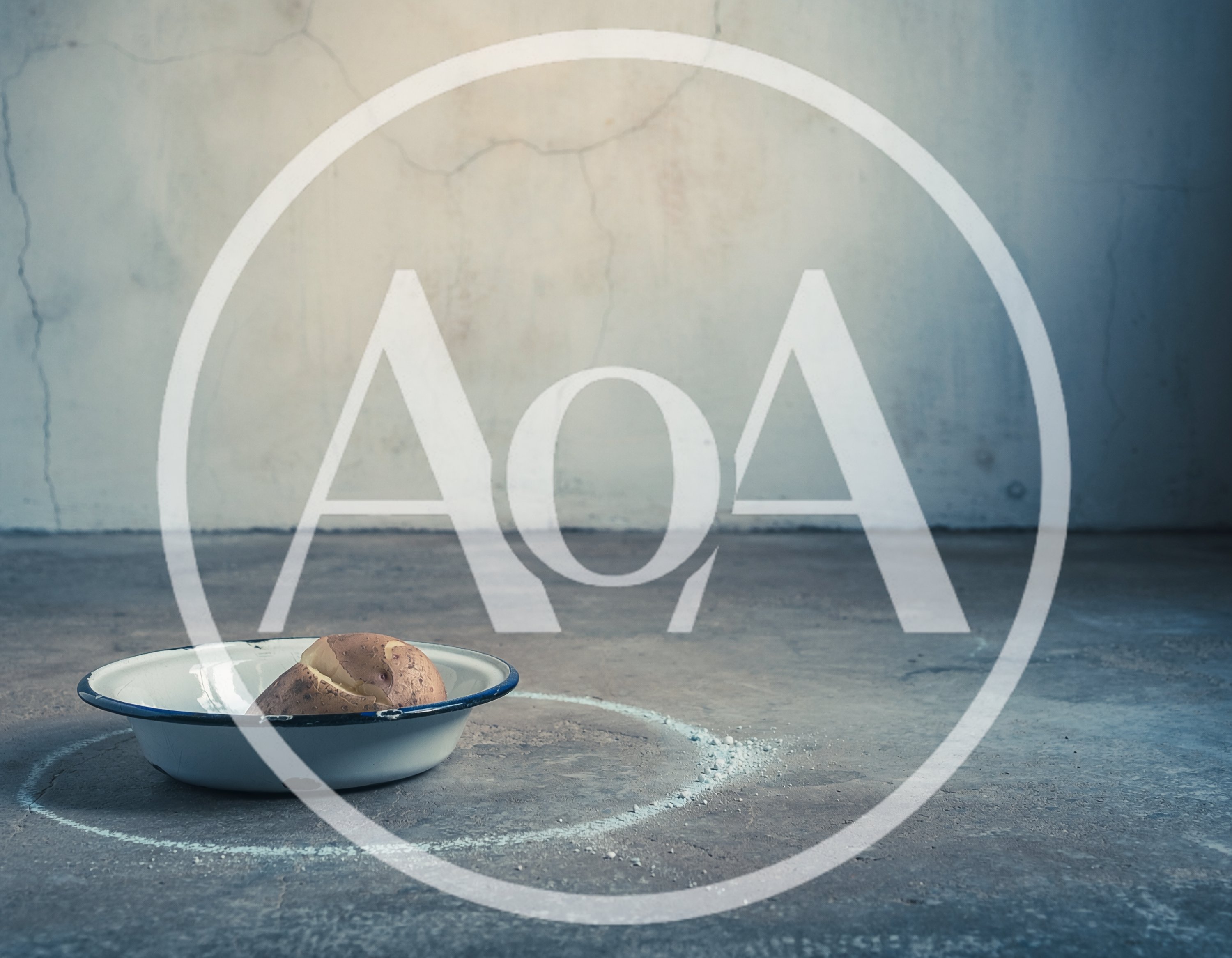 Single Potato In A Metal Bowl On Concrete Floor