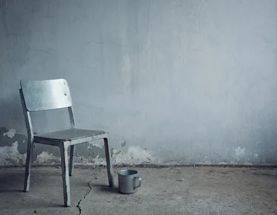 Old Metal Chair and Cup in Abandoned Room