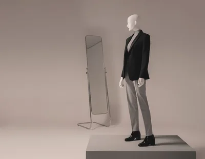 Mannequin Wearing Business Attire Beside A Standing Mirror