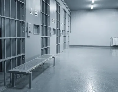 Empty Prison Corridor With Metal Cell Doors