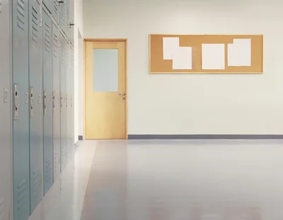 Empty School Hallway With Lockers And Bulletin Board