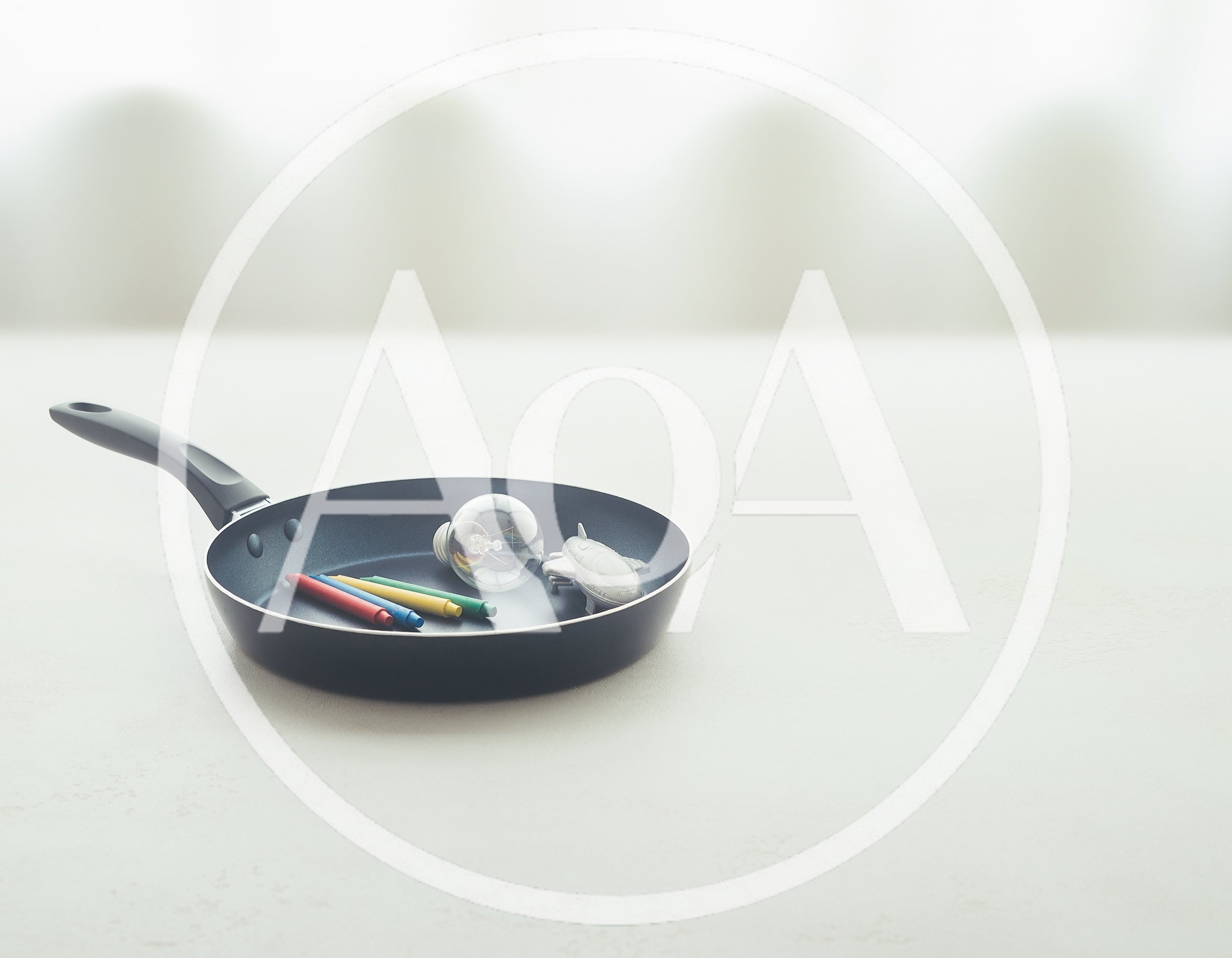 Light Bulb Crayons and Toy Airplane in Frying Pan