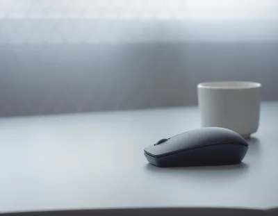 Minimalist Wireless Computer Mouse On A Desk
