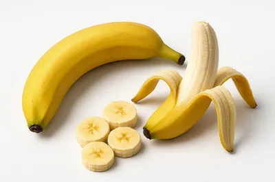 Fresh Bananas And Sliced Banana Pieces On White Background