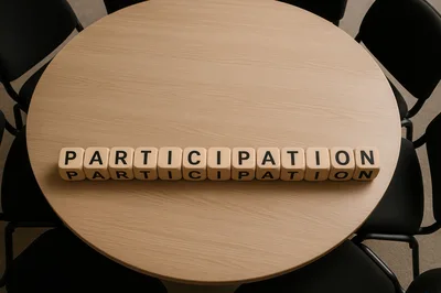 Wooden Blocks Spelling Participation On A Round Meeting Table