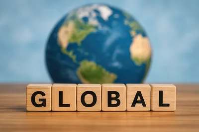 Wooden Blocks Spelling Global With A Blurred Globe Background