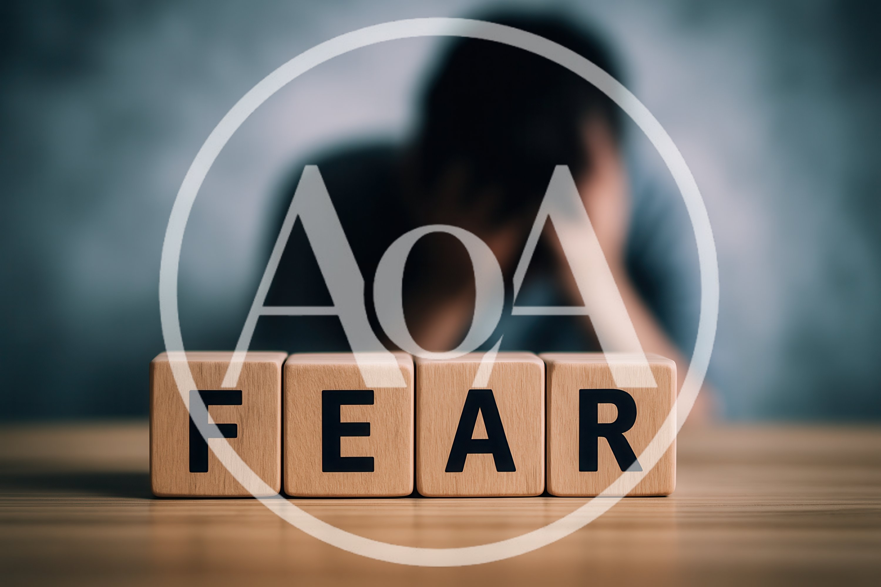 Wooden Blocks Spelling Fear With Distressed Person In Background