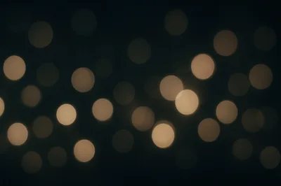 Abstract Golden Bokeh Lights On Dark Background