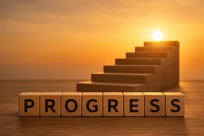 Wooden Blocks Spelling Progress With Staircase Background