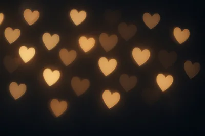 Golden Heart Shaped Bokeh Lights On Dark Background