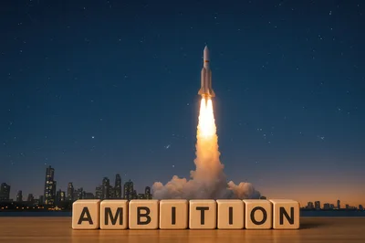 Rocket Launching Behind Wooden Blocks Spelling Ambition