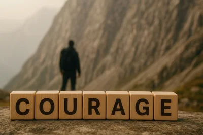 Wooden Blocks Spelling Courage With A Hiker In Background