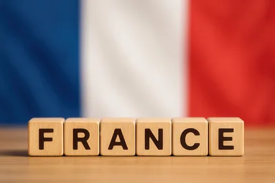 Wooden Blocks Spelling France Against French Flag Background