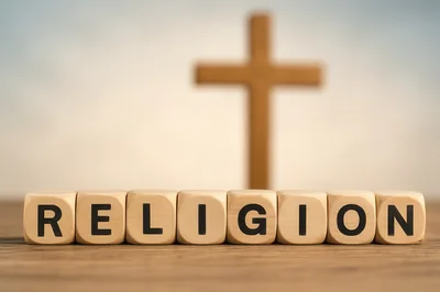 Wooden Blocks Spelling Religion With A Christian Cross