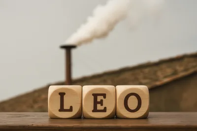 Wooden Blocks Spelling Leo With Industrial Smoke Background