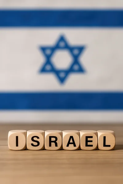 Wooden Blocks Spelling Israel With National Flag Background