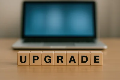 Wooden Blocks Spelling Upgrade In Front Of Laptop