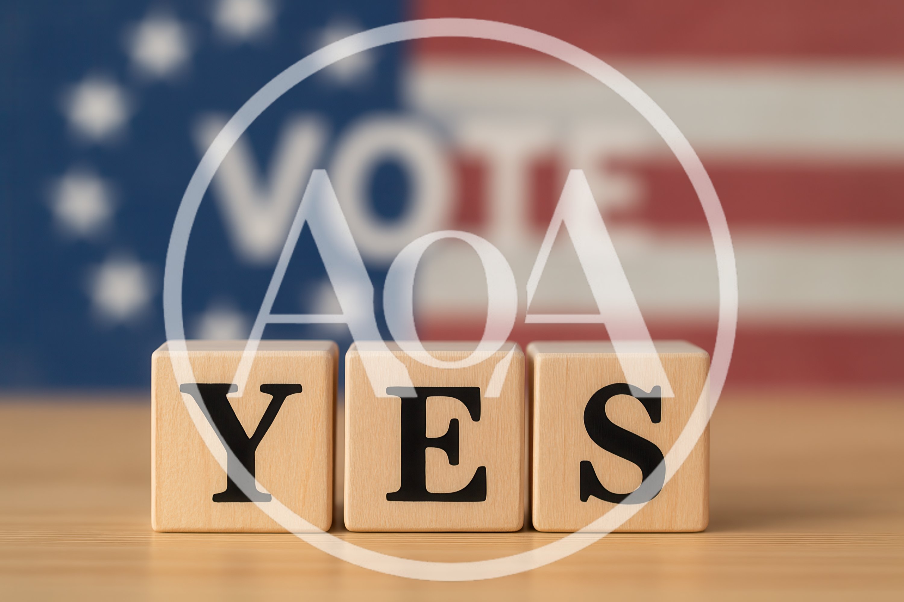 Wooden Blocks Spelling Yes With Blurred American Flag Background