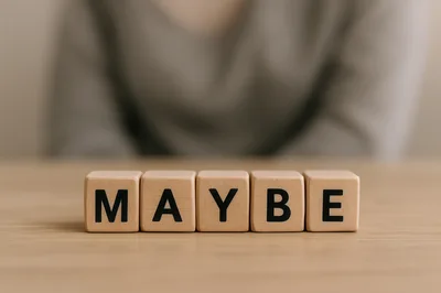 Wooden Blocks Spelling Maybe On A Wooden Table