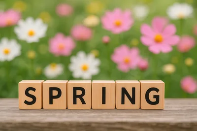 Wooden Blocks Spelling Spring on a Garden Table