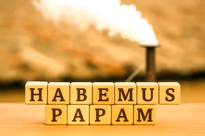 Wooden Blocks Spelling Habemus Papam With Vatican Chimney