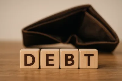 Wooden Blocks Spelling Debt With An Empty Wallet