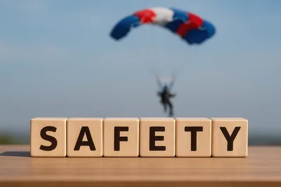 Wooden Blocks Spelling Safety With Parachutist Background