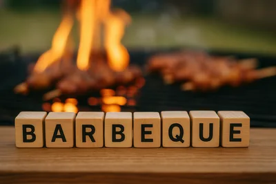 Wooden Blocks Spelling Barbeque on Grill Background