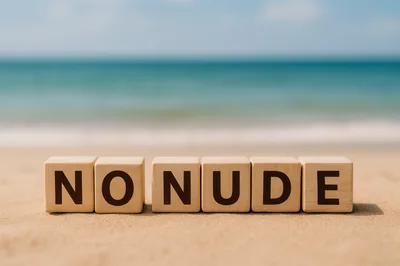 Wooden Blocks Spelling No Nude On Sandy Beach
