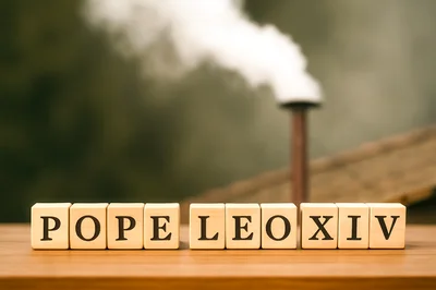 Wooden Blocks Spelling Pope Leo XIV With Chimney Smoke
