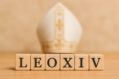 Wooden Blocks Spelling LEOXIV With A Mitre In Background