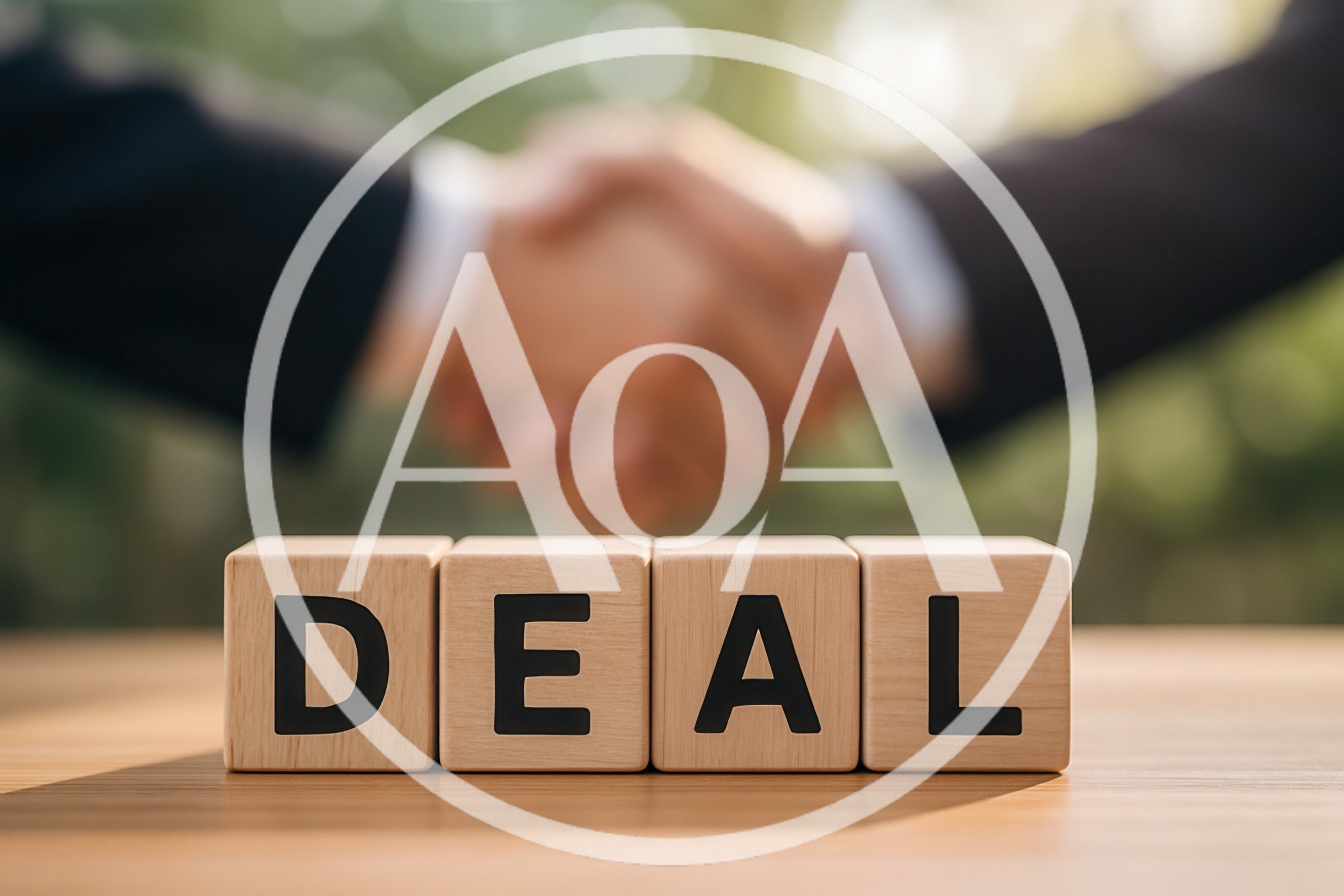 Business Handshake Behind Wooden Blocks Spelling Deal